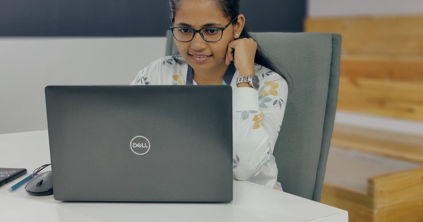 Office worker sitting at laptop, disengaged from work