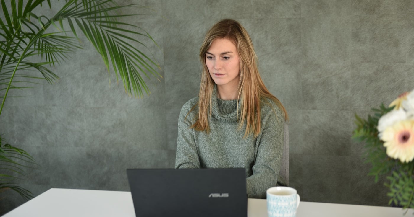 Person working on laptop in home office — remote work productivity